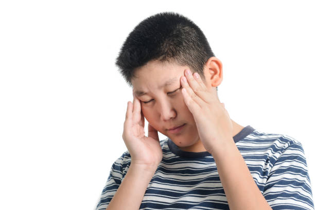 istock Asian preteen boy having headace on white background. 1159801051