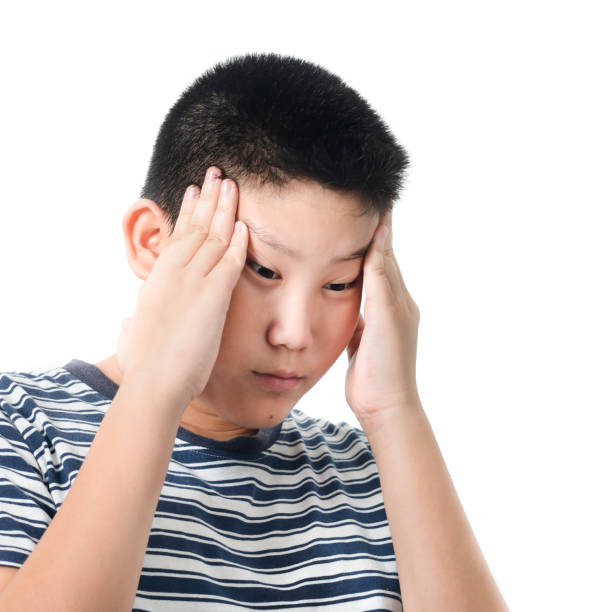 istock Asian preteen boy having headace on white background. 1159801342
