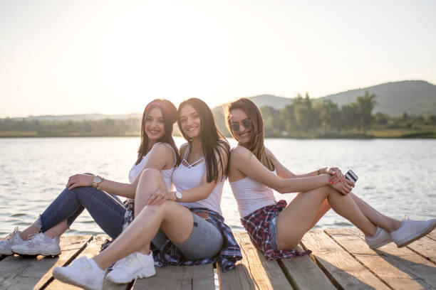 istock Young women having fun by the lake 1159802445
