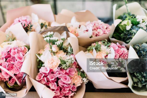 A Lot Of Flower Bouquets At The Florist Shop On The Table Made Of Hydrangea Roses Peonies Eustoma In Pink And Sea Green Colors Stock Photo - Download Image Now