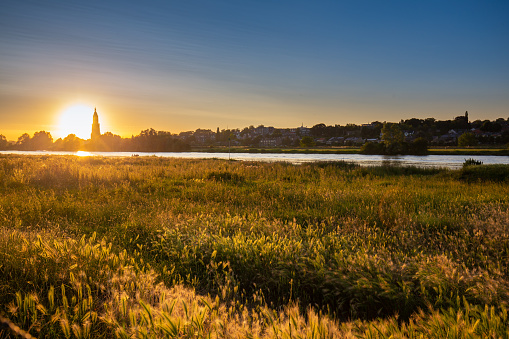 Skyline of the city of Rhenen during sunset with Cunera church and river Nederrrijn in the provence of Utrecht in the Netherlands