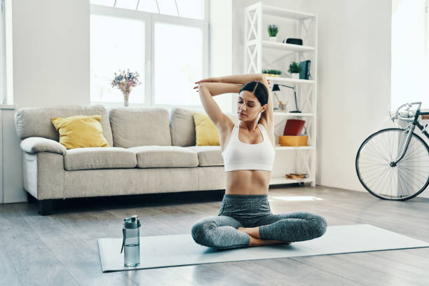 morning workout. - stretching women attractive female indoors imagens e fotografias de stock