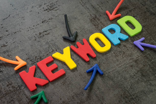 istock Keywords research for SEO, Search Engine Optimization, bidding on search result page to promote website online, multi color arrows pointing to the word Keyword at the center of black cement chalkboard wall 1159806660