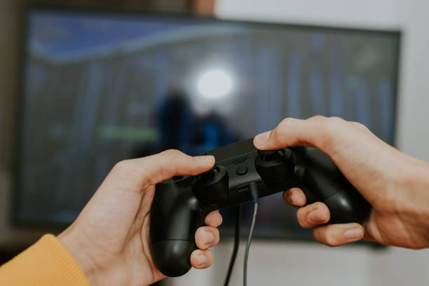 istock hand with the joystick playing video games 1159807139