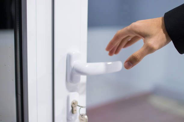istock hand opening the door 1159807215