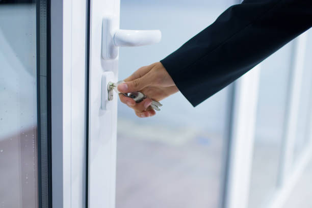 istock hand at the entrance door or access, lock and security 1159807320
