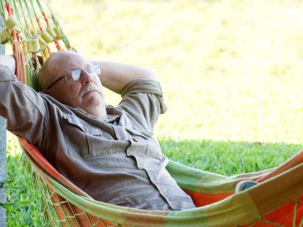 istock senior man relaxation in hammock 1159807334