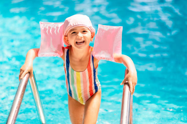 istock Cute little girl leaving the pool 1159808268