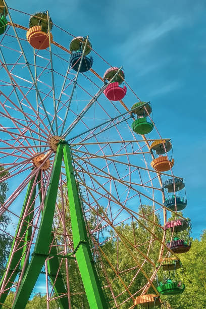 istock Multi-colored Ferris wheel in the park in a sunny day. 1159808705