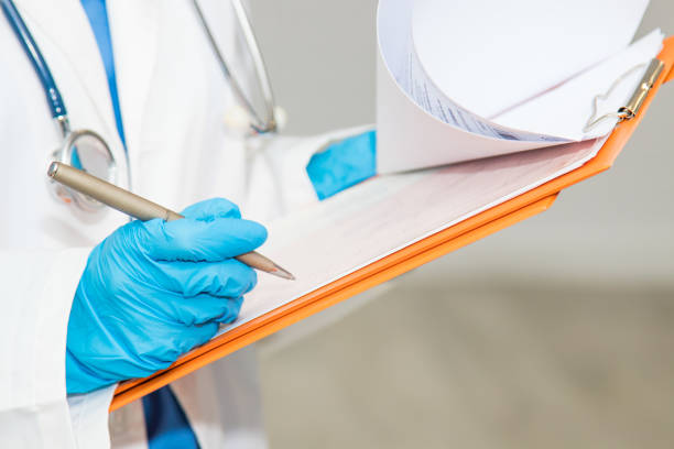 istock doctor with report folder or clinical history 1159808724