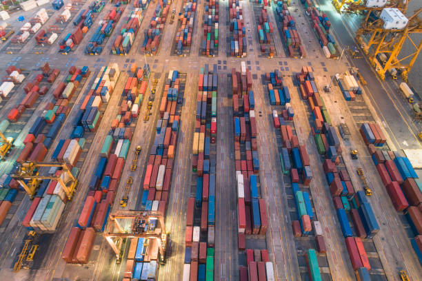 istock Logistics and transportation of Container Cargo ship and Cargo with working crane bridge in shipyard at sunrise, logistic import export and transport industry background 1159809779