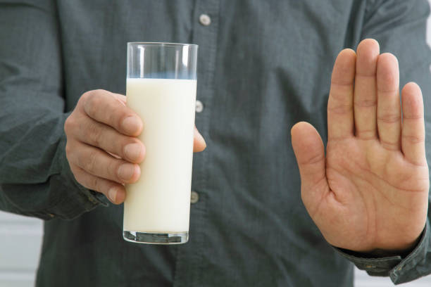 istock milk cup with stop sign or banned, lactose intolerance 1159810189