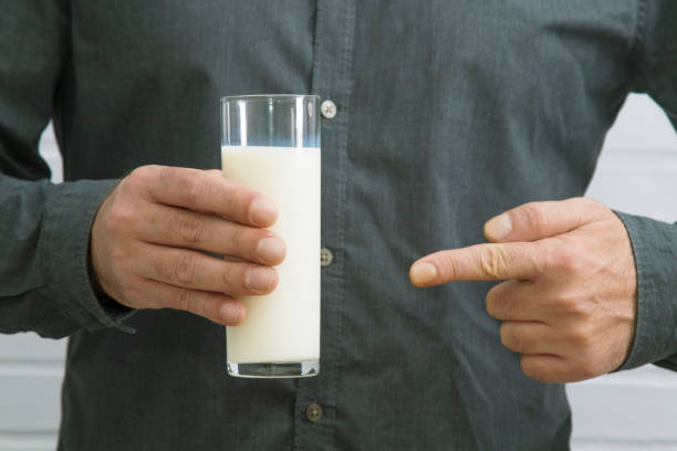 istock hand with glass of fresh milk 1159810564