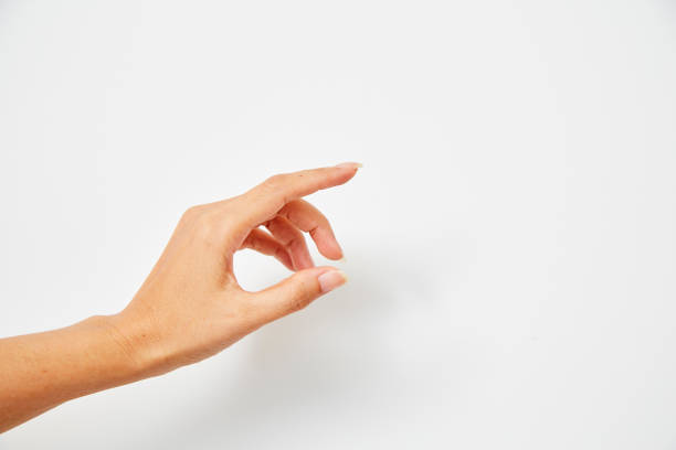 istock Woman hand pointing on white background 1159810580