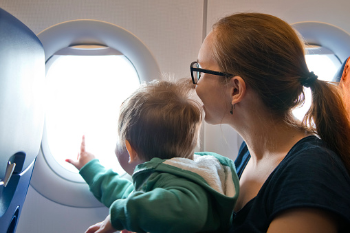 Mother and son traveling by airplane