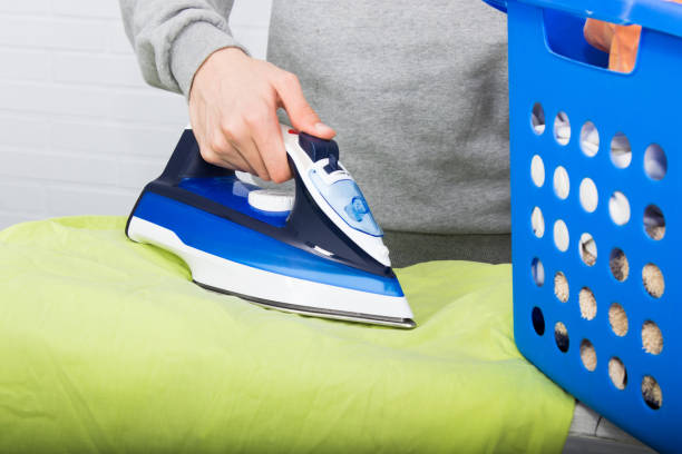 istock closeup view of the hand ironing clothes 1159811251