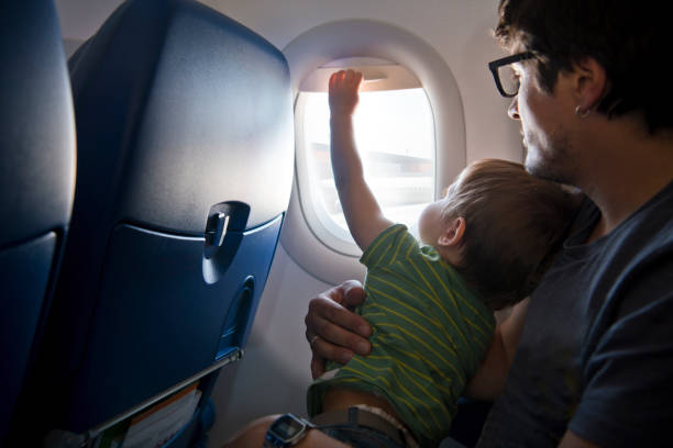 istock Naughty boy travelling by plane 1159811275