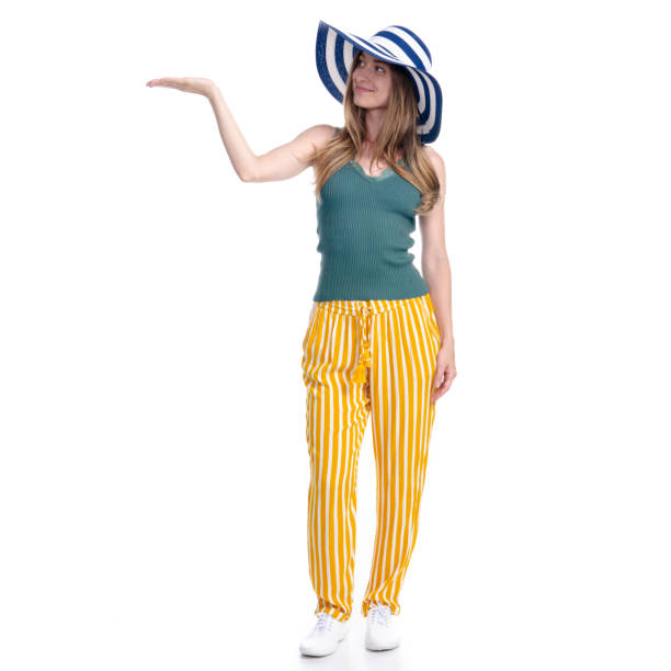 istock Woman with summer hat smiling happiness standing showing pointing 1159812251