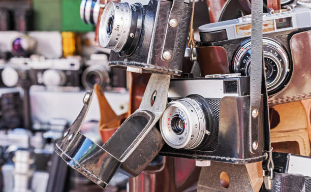 istock Vintage camera in a black leather case. Old camera at a flea market. 1159813518