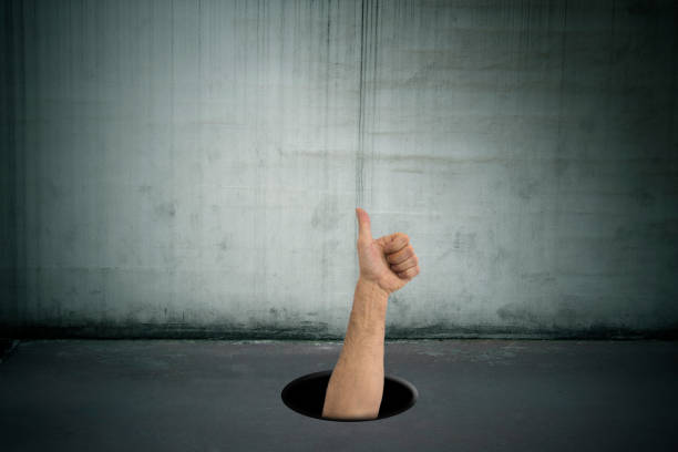 istock hand with okay signal dropping into the hole 1159814005