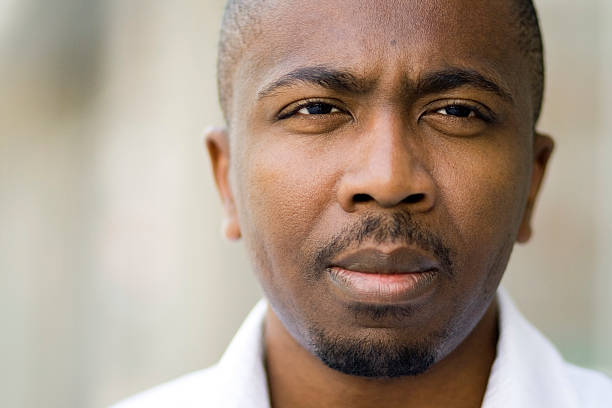 istock A man glaring at the camera while his photograph is taken 115981402