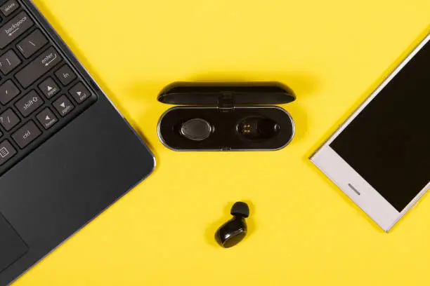 Flat lay composition with Electronics devices on yellow background