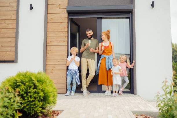 istock Happy nice children standing with their parents 1159816588