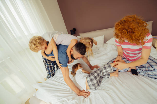 istock Delighted happy children playing with their parents 1159816631