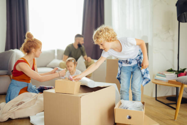 istock Pleasant cute boy taking something from the box 1159816649