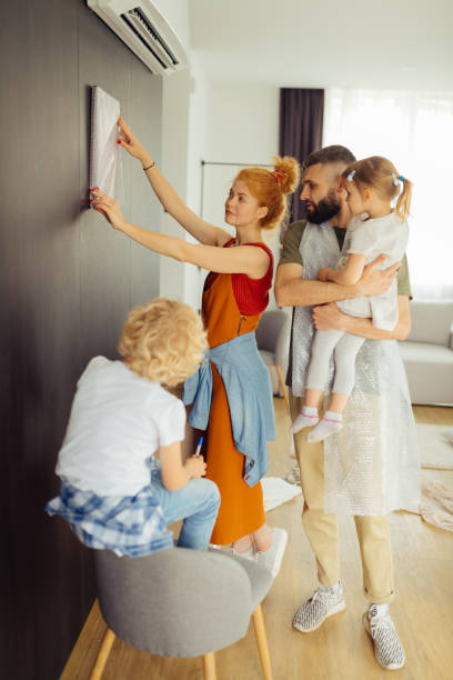 istock Pleasant young woman looking at the wall 1159816776