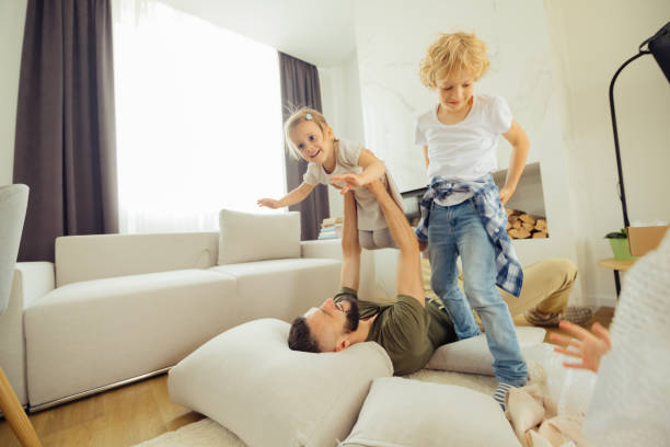 istock Joyful nice man lying on the floor 1159816798