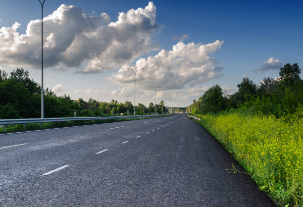 istock beautiful landscape car road and beautiful blue sky with white clouds 1159817074