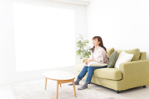 istock Young woman relaxing at home 1159817202