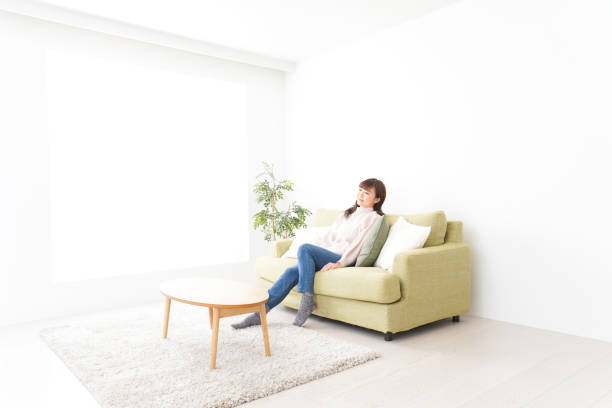 istock Young woman relaxing at home 1159817291