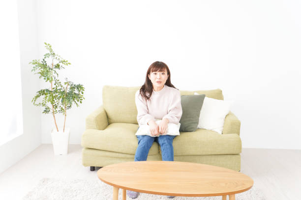 istock Young woman relaxing at home 1159817303