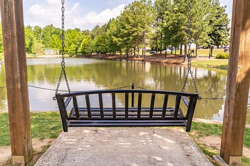 Inman, S.C. / USA - May 4, 2019: A swing overlooking the beautiful landscape in Cleveland Park, a newly rebuilt public space in Spartanburg county.