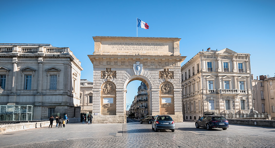 Montpellier, France - January 2, 2019: Architecture detail of the Arc de Triomphe and its street atmosphere on a winter day