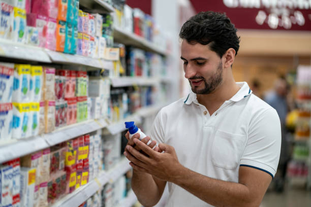 istock Single guy reading a label on product from shelf at the supermarket 1159821651