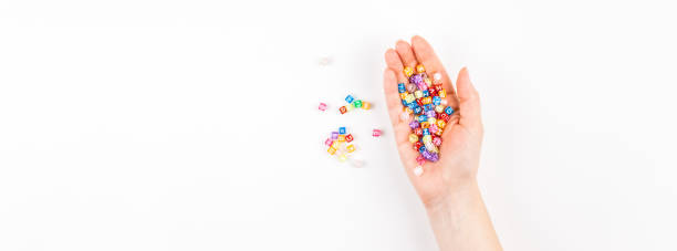 istock Woman hand with multicolor alphabet 1159824384
