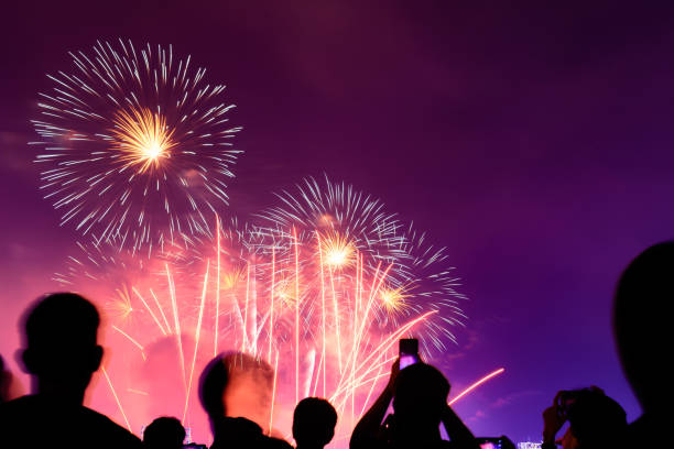 istock Crowd watching fireworks and celebrating city founded. Beautiful colorful fireworks display in the urban for celebration on dark night background. 1159824388