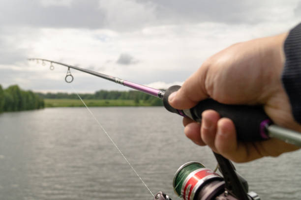 istock A human hand holding a spinning. Fishing process 1159824970