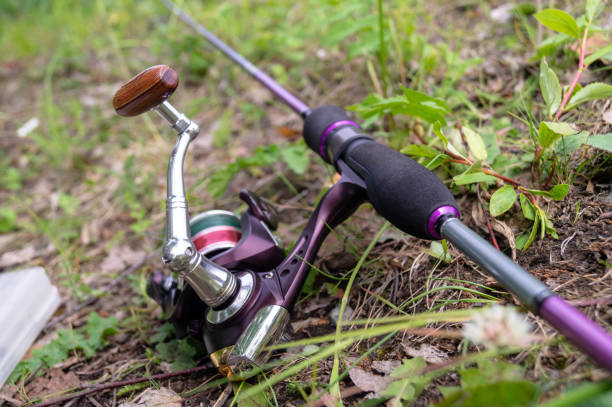 istock spinning lying on the ground. fishing tackle 1159825031