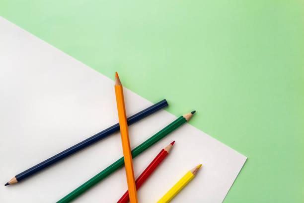 istock white sheet of paper and five pencils 1159825296