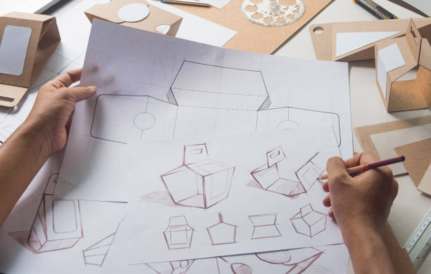 istock Designer sketching drawing design Brown craft cardboard paper product eco packaging mockup box development template package branding Label . designer studio concept . 1159825341