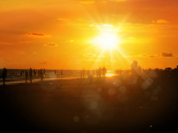 istock group of silhouetted people on public beach over orange colored sunset sky 1159827473