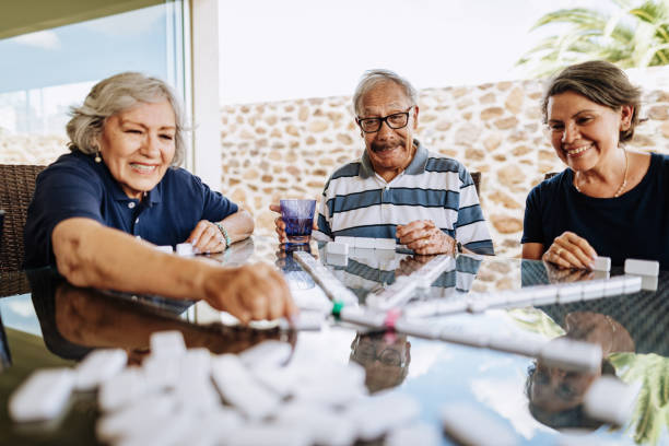 istock Latin seniors playing dominos and having fun 1159828627