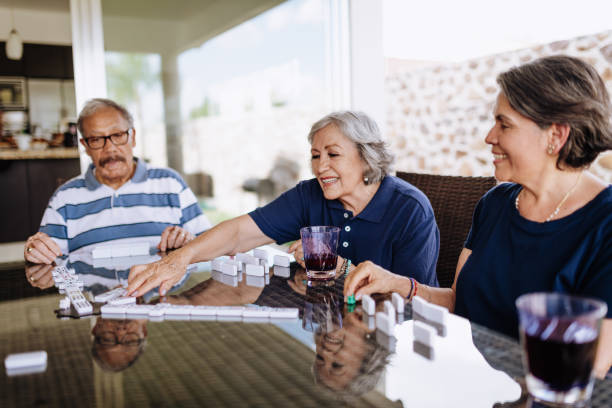 istock Latin seniors playing dominos 1159829658