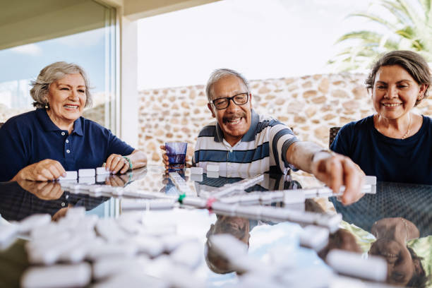 istock Latin cultures - Hispanic seniors playing dominos 1159829967