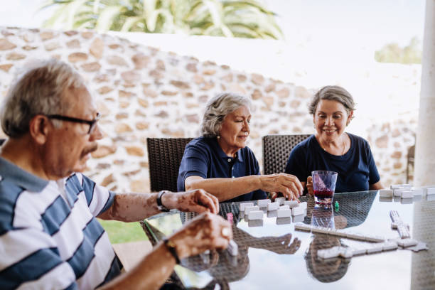 istock Mexican seniors playing dominos 1159829971