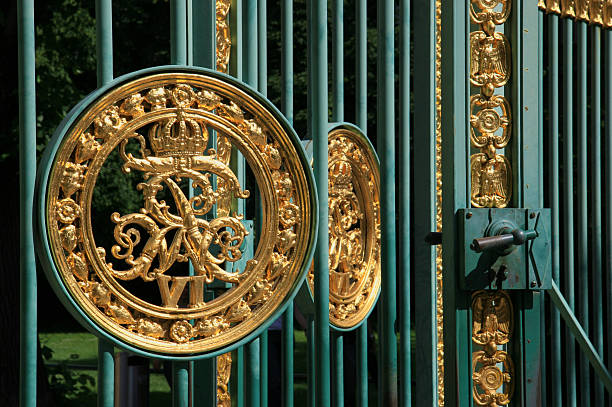 This is an entrance to a prussian park in Potsdam, with the prussian sign of the kings. This Sign is from the 19th century. 